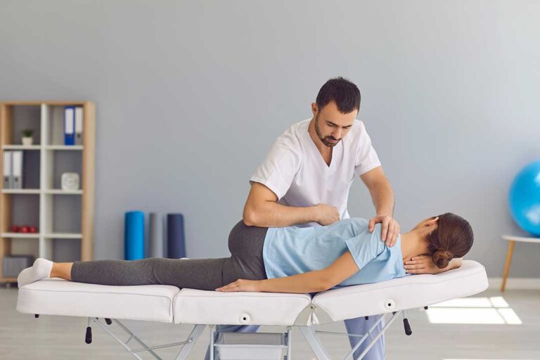 Person gently stretching their neck while seated in a bright, comfortable living room.